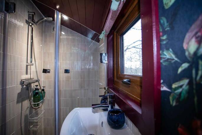Bathroom with a hot shower, sink and compost loo