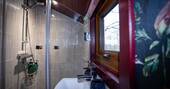 Bathroom with a hot shower, sink and compost loo