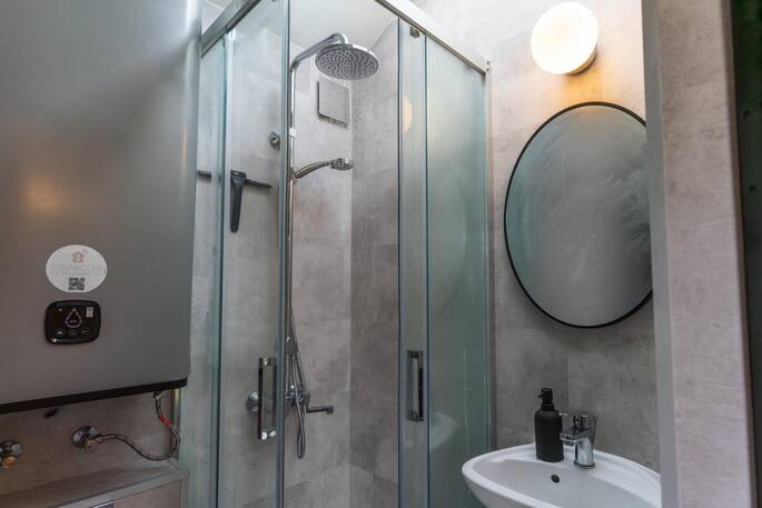 Bathroom with a hot shower sink and flushing toilet