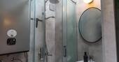 Bathroom with a hot shower sink and flushing toilet
