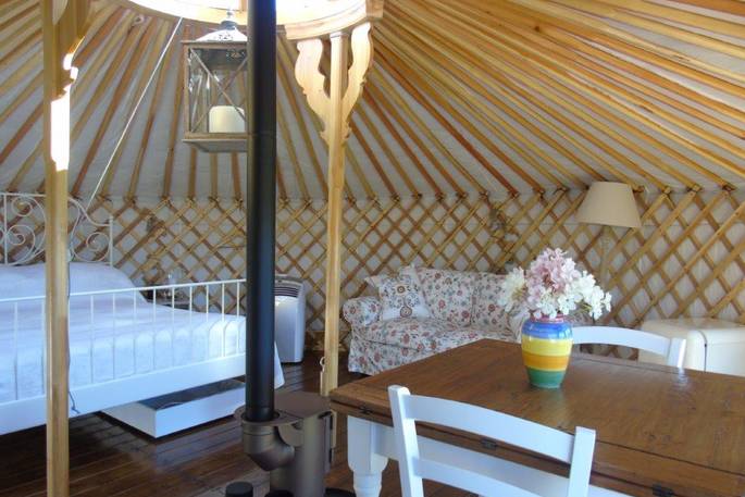 handcrafted mongolian yurt holiday italy interior bedroom and woodburner 