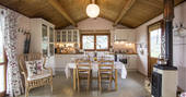 The Pool House at Glamping Abruzzo interior living space with wood-burner, dining table and kitchen 