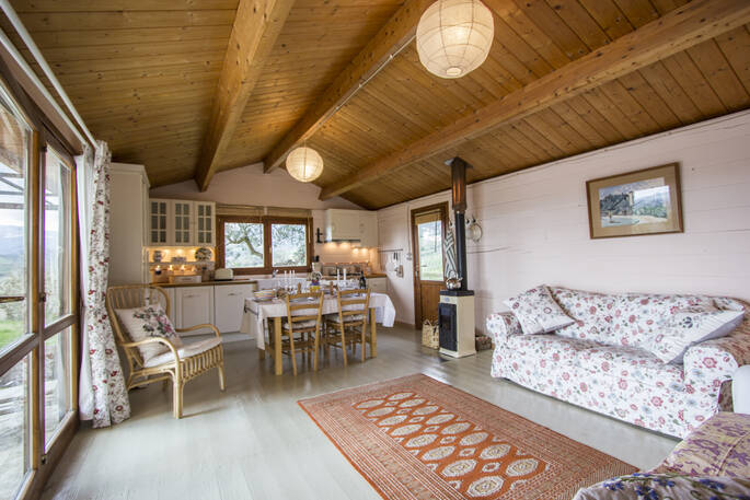 The Pool House cabin interior open plan living space with dining table and well-equipped kitchen in Abruzzo, Italy