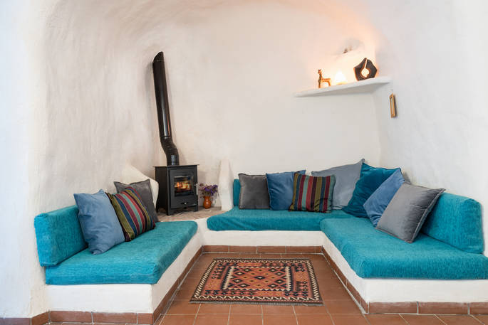 Casa Isadora Cave House seating area with wood burner, Almeria, Spain