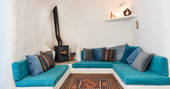 Casa Isadora Cave House seating area with wood burner, Almeria, Spain