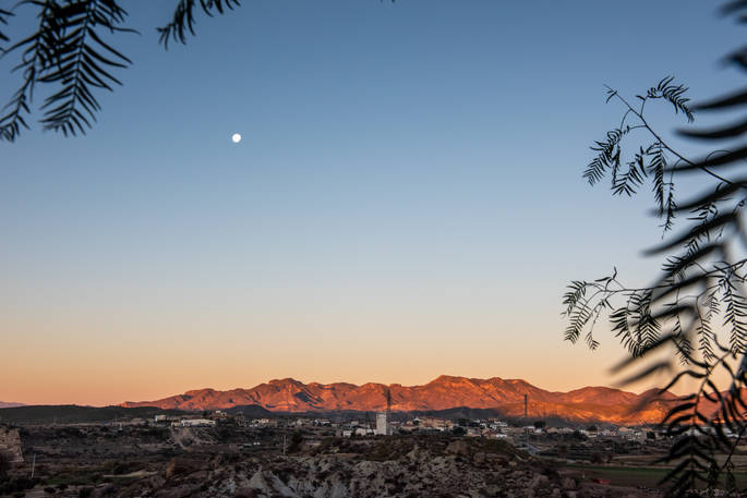 Old moon and mountains at dawn, Casa Isadora Cave House, Almeria, Spain