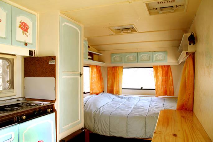 Double bed inside of La Caravana in the corner of the caravan at Casabayacas 